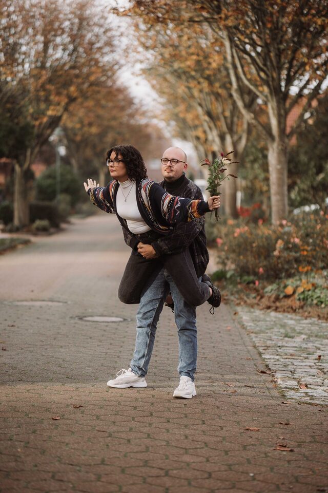 Paarshooting ohne Stock im… ihr wisst schon: Partner trägt Partnerin, Strauß in der Hand, Herbstallee – Patricia Bakker